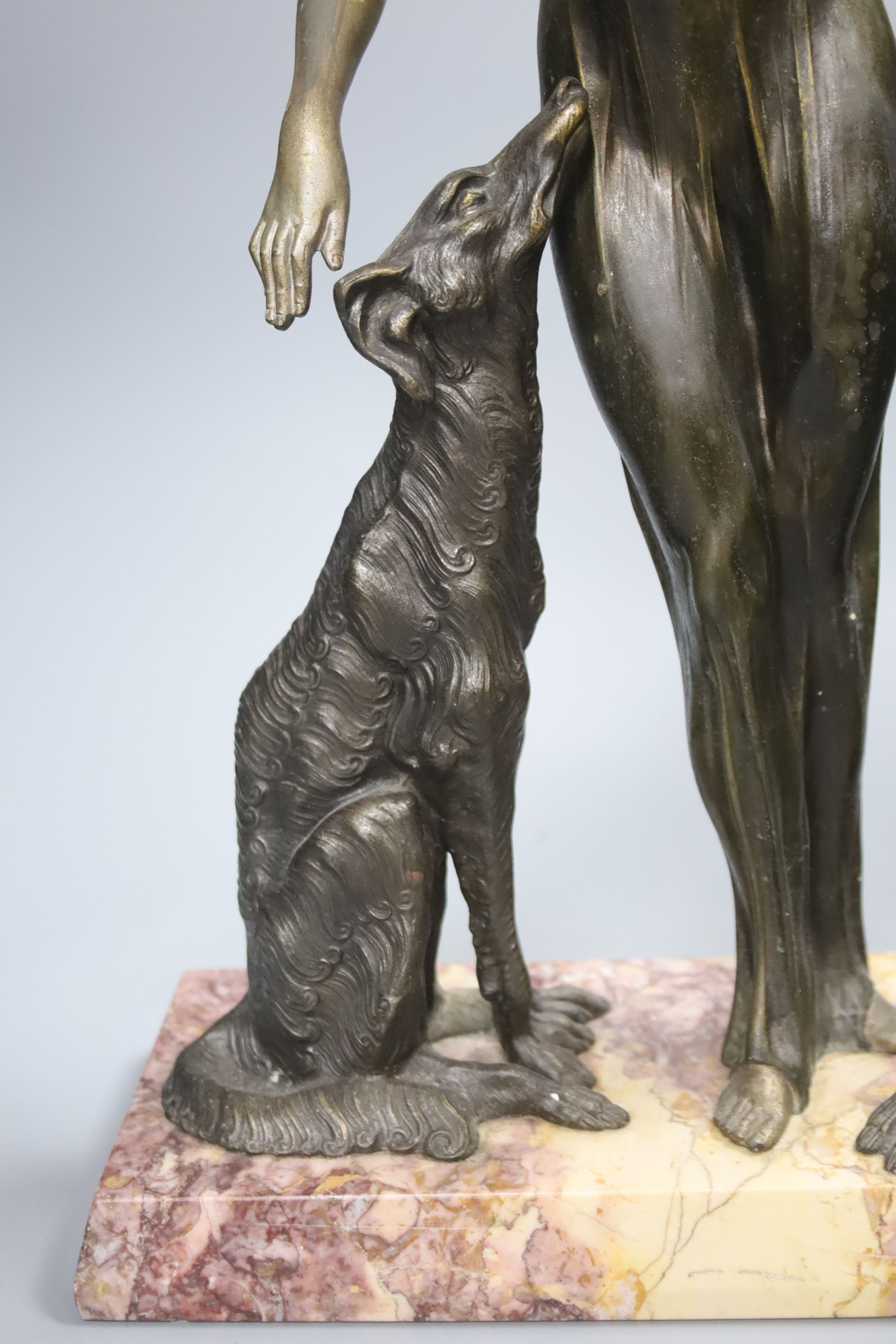 A Spelter Art Deco figure of a dog and borzoi, on a marble base, height 45cm